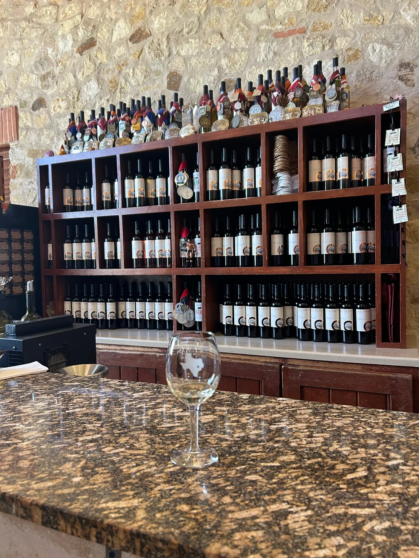 Bottles lined up along the tasting bar of a Hill Country winery.