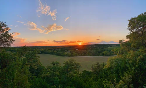 Sunset over the vineyard valley seen from the ridge at Driftwood Estate Winery.